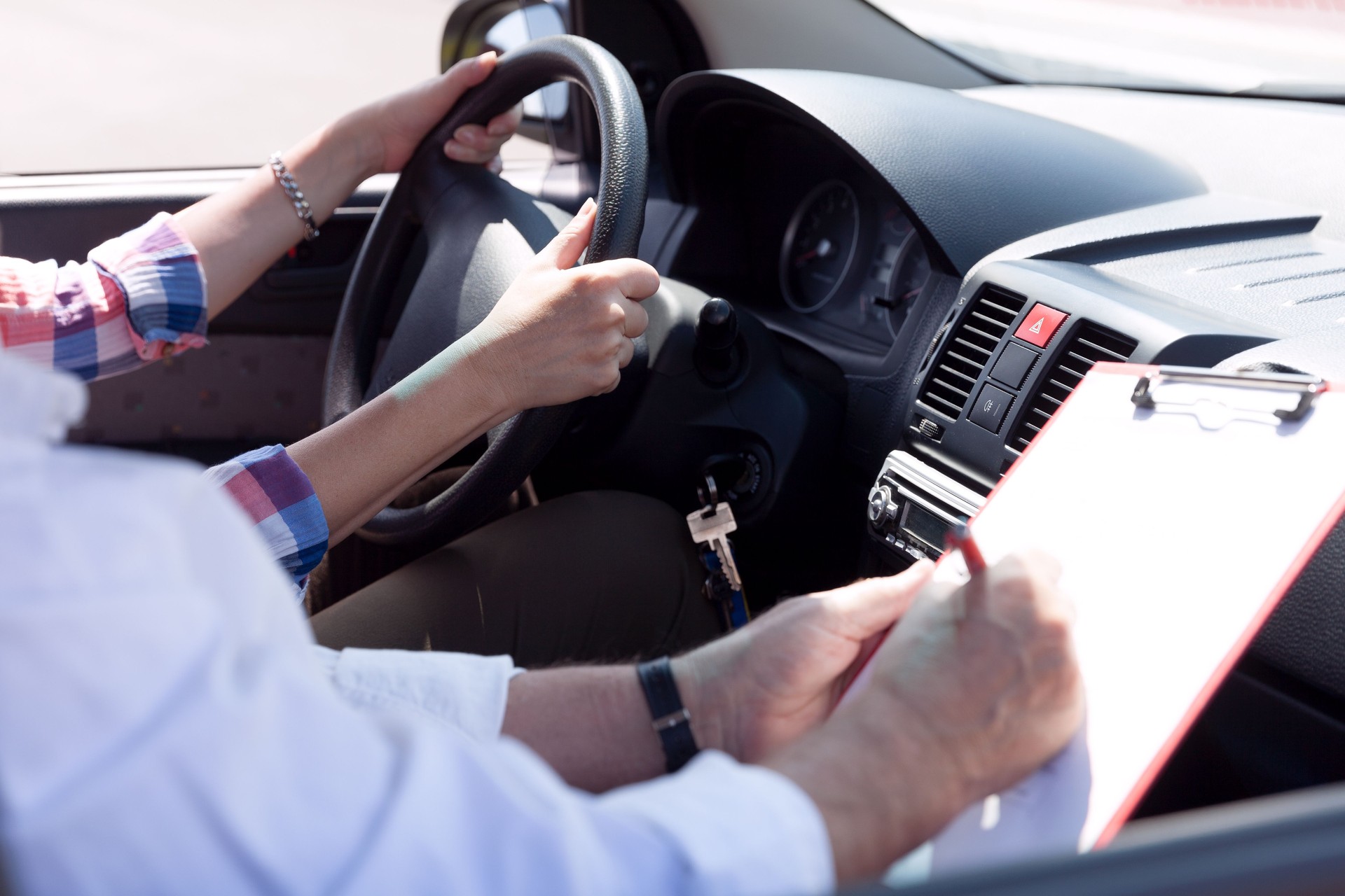 Learner driver student driving car with instructor